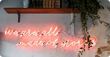 Neon sign that reads We are all made of stories