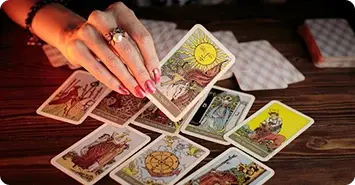 A hand picking up a card from a pile of cards